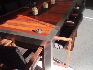 Custom-designed stainless steel & wood integrated dining table